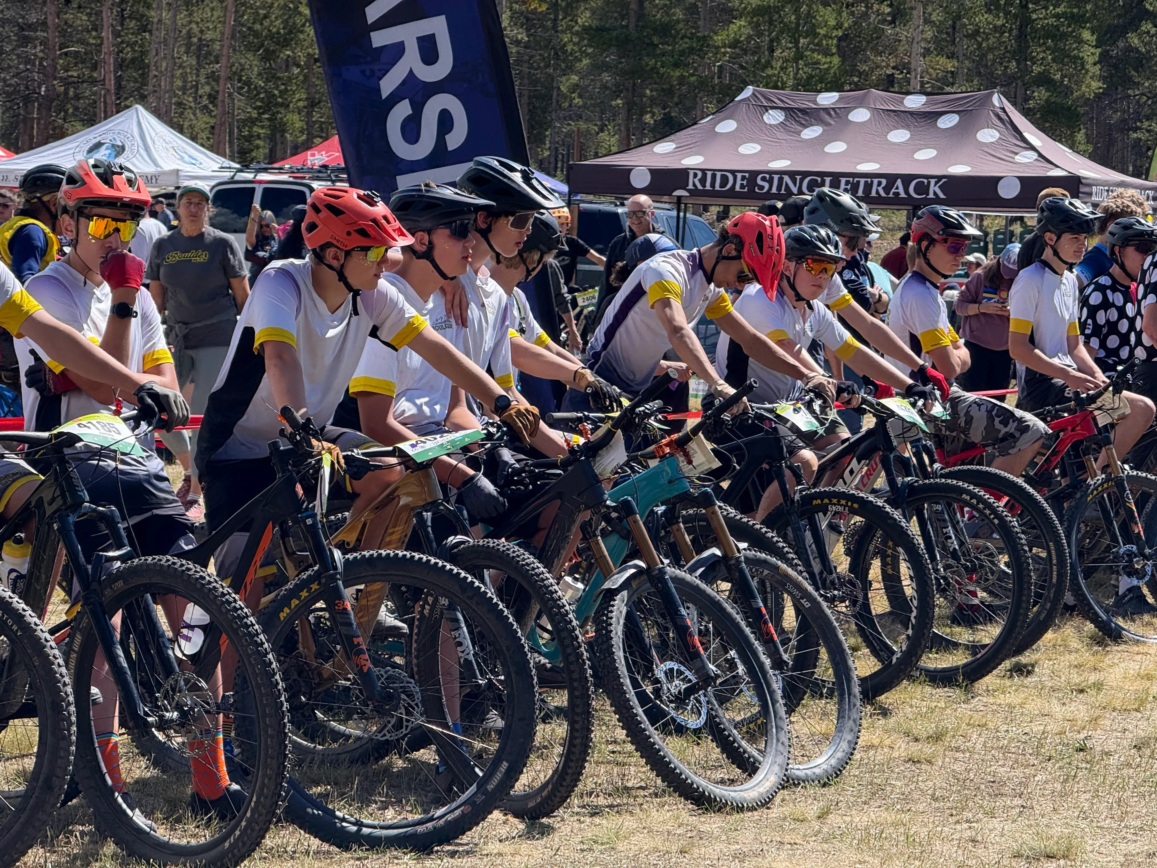 A line of Boulder High riders at the start gate of the Leadville race in team kit