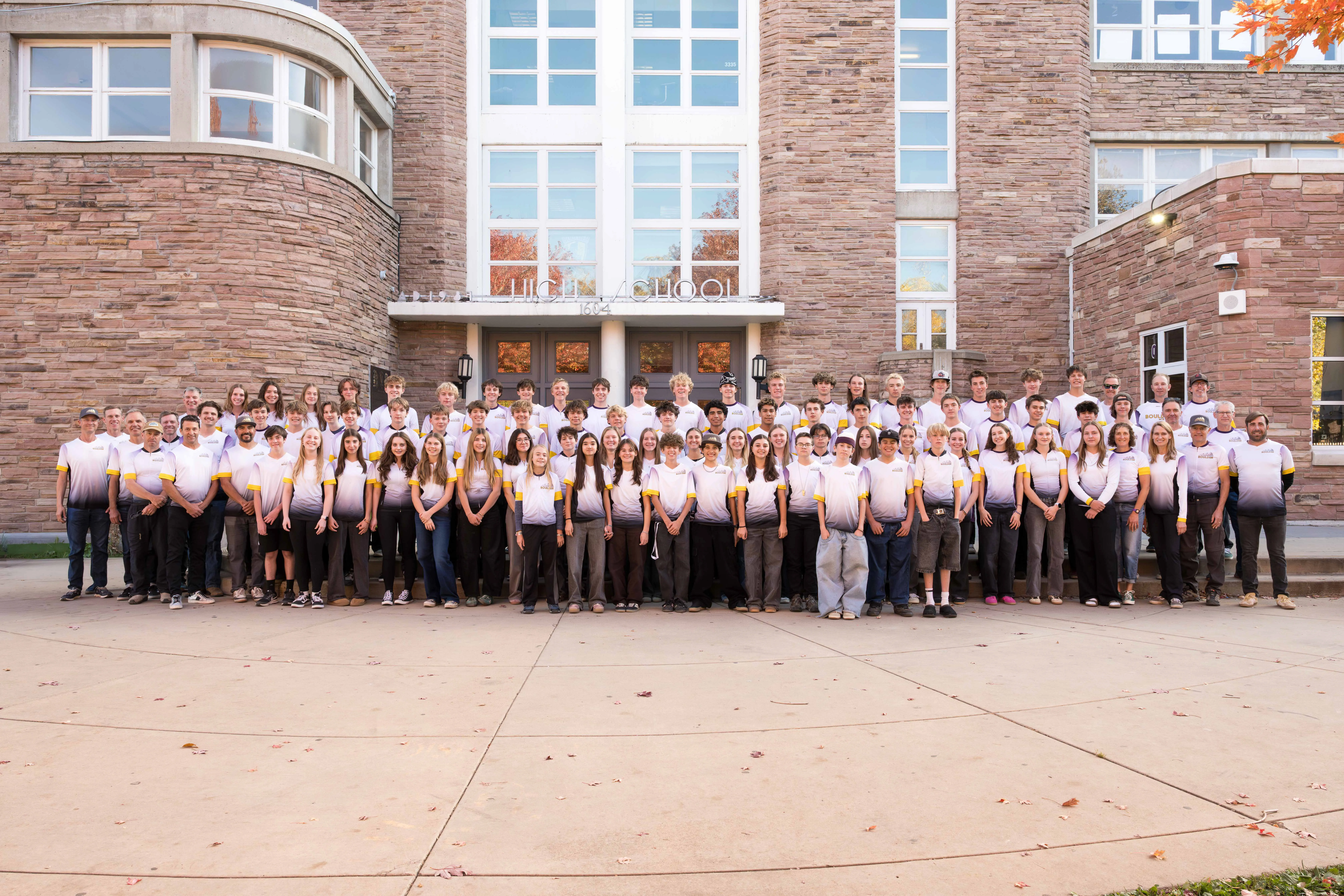 The Boulder High Mountain Bike Team posing together on the steps of Boulder High School
